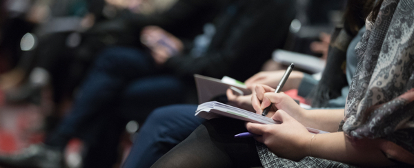 attendees taking notes